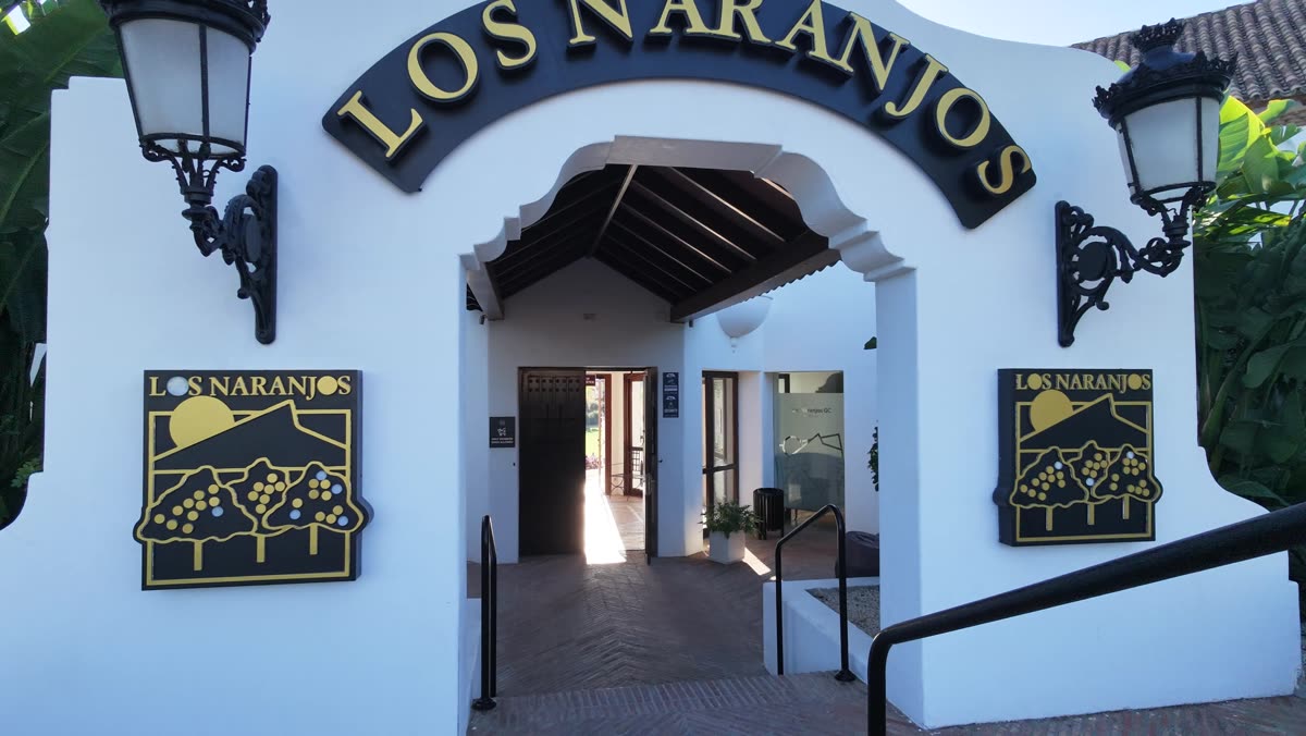 Club entrance with the Los Naranjos sign